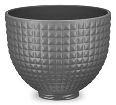 a black bowl is shown on a white background and it has an interesting design in the center