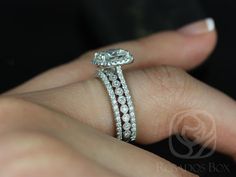 a close up of a person's hand with a diamond ring on their finger