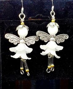 Adorable little Snow fairies dangling from your ears are sure to gather compliments of cuteness. Approx 1.25 to 1.5 inches long. French hook with silcone stopper on ear wire which is also made of Sterling Silver. White lucite flowers, white glossy glass bead, and silver colored wings and hat are used to create these little fairies. Whimsical Dangle Flower Earrings, Whimsical White Jewelry With Flower Charm, Whimsical Silver Flower Earrings, Silver Whimsical Flower Earrings, Whimsical Silver Flower Earrings With Ear Wire, Whimsical White Flower Earrings With Ear Wire, Whimsical White Flower Earrings, Angelic White Jewelry For Gifts, Whimsical Silver Dangle Flower Earrings