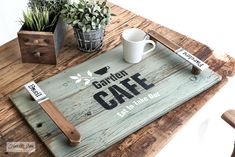 a wooden table topped with a coffee cup and tray