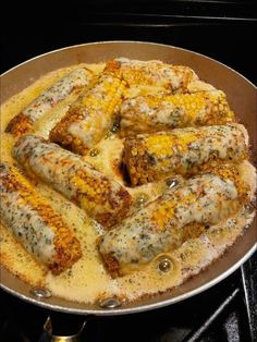 some food is being cooked in a pan on the stove and ready to be eaten