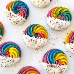 rainbow cookies with white frosting and sprinkles