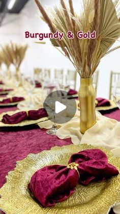 an image of a table setting with purple linens and gold place settings on it