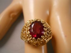 Gorgeous designer signed / marked vintage estate heavy ( 4.31 grams approximately ) & wide ( 15mm wide at its widest points approximately ) 14k 14kt karat solid yellow gold center genuine natural real oval cut red garnet gemstone ornate frosted textured brushed diamond cut style gold scroll filigree gold bead gold ball gold rope trim byzantine etruscan halo tier heart art deco victorian floral flower cocktail designer style band ring this is a beautiful & stunning ring the beautiful garn Valentine's Day Yellow Gold Jewelry With Intricate Design, Heirloom Oval Jewelry For Valentine's Day, Victorian 14k Gold Jewelry For Valentine's Day, Red Filigree 14k Gold Jewelry, Red 14k Gold Filigree Jewelry, 14k Gold Filigree Ruby Ring Gift, 14k Gold Ruby Ring With Filigree For Gift, Gold Filigree Ruby Ring Fine Jewelry, Gold Ruby Ring With Filigree Fine Jewelry