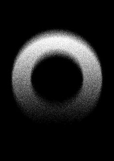 a black and white photo of a circular object in the air with some light coming from it