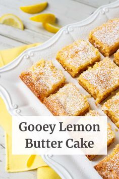 gooey lemon butter cake on a white platter with the words gooey lemon butter cake