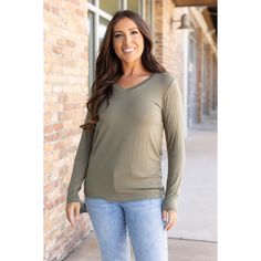 Add sophistication to your everyday attire with the Larissa Long Sleeve Top in olive. This essential V-neck top blends timeless style with modern comfort, making it perfect for any occasion. Crafted from a soft mix of 95% rayon and 5% spandex, it offers a snug yet flexible fit that moves with you. Whether you're dressing up for a night out or keeping it casual for a day in, this top ensures you stay cozy with its long sleeves and relaxed fit. Fabric Composition: Premium blend of 95% rayon and 5% Olive V-neck Tops For Spring, Casual Olive V-neck Top, Stay Cozy, V Neck Tops, Timeless Style, Long Sleeve Top, Final Sale, Timeless Fashion, Night Out