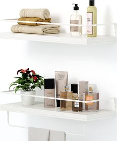 two white shelves filled with personal care items and a potted plant on one shelf