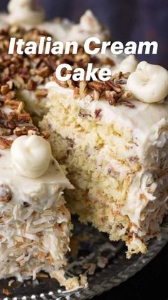 a cake with white frosting and pecans on top is cut in half to show the inside