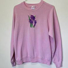 Adult L Jerzees cotton poly blend 44" chest 24" length Rad vintage Jerzees pink crewneck sweatshirt with a purple iris on the chest-- def had some wear on the embroidered graphic and there's a spot on the chest and some discoloration on the wrists. Still super cool and wearable. Purple Cotton Crew Neck Sweater, Retro Long Sleeve Purple Sweatshirt, Retro Purple Long Sleeve Sweatshirt, Purple Crew Neck Sweatshirt For Spring, Spring Purple Crew Neck Sweatshirt, Lavender Crew Neck Sweatshirt For Fall, Lavender Long Sleeve Cotton Sweatshirt, Lavender Long Sleeve Sweatshirt For Spring, Pink Crew Sweatshirt For Spring