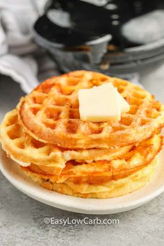 a stack of waffles with butter on top