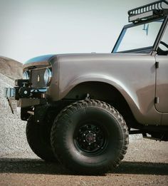 an off road vehicle parked on the side of a hill with no wheels or tires