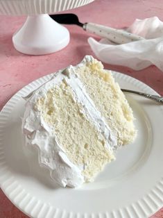 a piece of cake sitting on top of a white plate next to a knife and fork