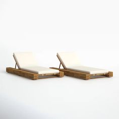 two white lounge chairs sitting next to each other on top of a white flooring