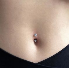 a woman's stomach with a diamond ring on it, and the bottom part of her tummy