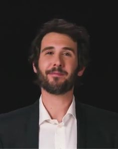 a man with a beard wearing a suit and white shirt