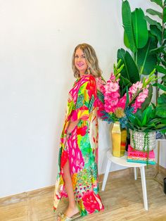 Step into summer with the Floral Button Down Dress! Featuring a vibrant multi-color watercolor pattern and a flowy fit, this button-down dress is perfect for warm days and makes an excellent coverup. PRODUCT FIT - OVERSIZED FIT MODEL DETAILS - BRENNA IS 5'3" BUST CIRCUMFERENCE - 60" LENGTH -53" FABRIC CONTENT - 100% MODAL CARE INSTRUCTIONS - COOL HAND WASH *PICTURES ARE EDITED TO ENHANCE COLORS* Multicolor V-neck Vibrant Print Beach Dress, Multicolor V-neck Beach Dress With Vibrant Print, Vibrant Summer Maxi Dress, Pink Abstract Print Maxi Dress For Summer, Vibrant Green Vacation Dress, Pink Maxi Dress With Abstract Print For Summer, Vibrant Green Dress For Vacation, Vibrant Multicolor Print Beach Dresses, Vibrant Multicolor Print Dresses For The Beach