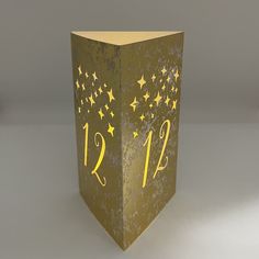 a gold box with numbers and stars on it