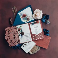 the wedding stationery is laid out on top of each other, including an envelope and matching cards