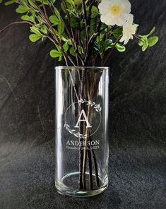 a glass vase with some flowers in it