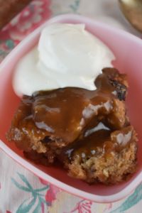 a close up of a plate of food with ice cream and cake in the background