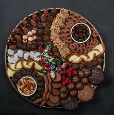 a platter filled with assorted chocolates and pretzels