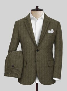 Make a striking statement without overpowering your surroundings with our Highlander Olive Herringbone Tweed Suit—a masterpiece that redefines elegance. Crafted from sumptuous olive green tweed, this suit features a meticulously woven herringbone pattern that adds depth and texture, echoing the beauty of nature itself. Whether you’re enjoying a glass of wine under the stars or engaging in lively conversation amidst the vibrant hues of fall, this suit is the epitome of timeless style.   Look Includes   Highlander Olive Herringbone Tweed Fabric   Two Button Jacket Style  Notch Lapel    Horn Royal Black  Buttons  Single Vent  Three Cuff Buttons  Two Welted Back Pockets on Trousers    Click 'Customize Now' to modify the look if needed.   Lining: Viscose. Tweed Suit, Green Tweed, Herringbone Tweed, A Glass Of Wine, Tweed Suits, Button Jacket, Glass Of Wine, Tweed Fabric, Herringbone Pattern