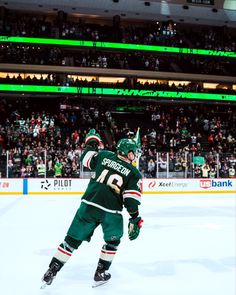 a hockey player on the ice in front of an audience