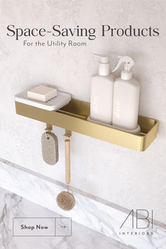 a bathroom shelf with soap and lotion bottles on it in front of a marble wall