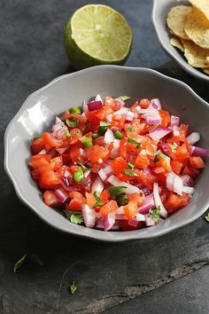 a white bowl filled with salsa next to tortilla chips