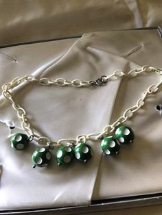 "Very cute fun costume jewelry from the 1940's-50's. Plastic chain link could be celluloid or maybe Bakelite. Little green and white dotted balls are possible the same. Playful costume jewelry from the 1940's. Measurements are; From end to end 17\" Feel free to convo me with any further questions. Thank you for your interest." Handmade Retro Bakelite Jewelry, Green Fun Plastic Jewelry, Fun Green Plastic Jewelry, Handmade Retro Green Jewelry, Retro Bakelite Jewelry As Gift, Playful Green Plastic Jewelry, Vintage Plastic Jewelry For Gifts, Retro Lucite Jewelry As Gift, Retro Lucite Jewelry Gift