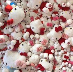 a pile of hello kitty stuffed animals on display