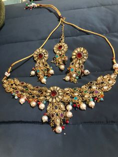 Adorable, effortless minimal and unique! A complete guide to cute outfits and style lover aesthetics❤️ This one is made for a charmer like you with all the love from Noorzaracollection! This beautiful Indian kundan multi stones necklace, drop earrings and mang tikka set is ready to ship. Color : multi, Hand crafted and gold plated kundan indian/pakistani jewelry Material:brass,stone,gemstone,pearl We bring you casual as well as party wear jewelry which comes with an attractive design and style. Bohemian Kundan Necklace With Stone Work For Festive Occasions, Multicolor Kundan Necklace With Latkans For Party, Bohemian Kundan Necklace For Diwali Party, Bohemian Kundan Necklace For Festive Gift, Bohemian Kundan Bridal Necklace For Diwali, Bohemian Kundan Necklace For Wedding And Festivals, Multicolor Kundan Necklace For Festive Occasions, Bohemian Kundan Tilla Necklace For Celebrations, Elegant Multicolor Kundan Necklace With Latkans