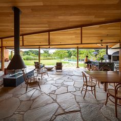 an outdoor living area with stone flooring and wood ceiling