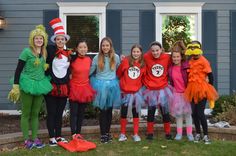 a group of children dressed up in costumes posing for a photo outside their house with dr seuss and the cat in the hat