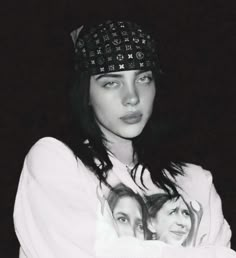 a black and white photo of a woman with her arms crossed wearing a headband