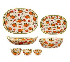 an assortment of dishes with pumpkins and leaves painted on the front, side, and back