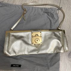 Miu Miu Small Clutch Bag Great For Formal Wear. Small And Good For Formals In Light Gold. All Leather. New Condition Only Worn Once. In Original Dust Bag. Party Shoulder Bag With Palladium Hardware And Top Handle, Miu Miu Leather Evening Shoulder Bag, Miu Miu Formal Shoulder Bag With Gold-tone Hardware, Formal Miu Miu Shoulder Bag With Gold-tone Hardware, Designer Shoulder Bag With Fold Over Clasp, Party Shoulder Bag Satchel With Palladium Hardware, Gold Shoulder Bag With Palladium Hardware For Evening, Designer Miu Miu Shoulder Bag With Gold-tone Hardware, Miu Miu Satchel Shoulder Bag For Evening