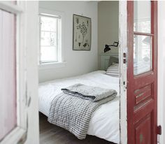 an open door leading to a bed in a bedroom