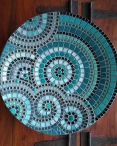 a blue and white plate sitting on top of a wooden table next to a door