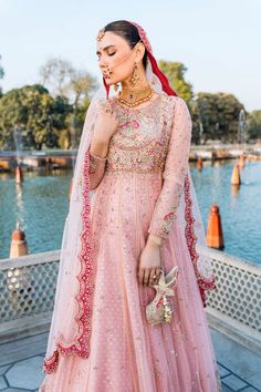 Pink Pakistani Bridal Dress in Frock Lehenga Style is an elegant attire adorned with Hand-crafted embellishments. This Lehenga Dress is available Online. Pakistani Pink Lehenga, Pink Engagement Dress Pakistani, Pink Pakistani Bridal Dress, Tea Pink Bridal Dress Pakistani, Pink Naqshi Lehenga, Blush Pink Pakistani Dress, Pink Frock, Lehenga Dress, Pakistani Bridal Dress