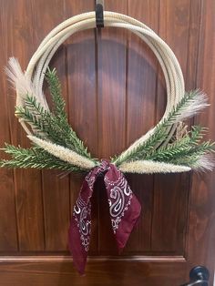 a wreath hanging on the front door of a house