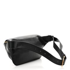 This is an authentic SAINT LAURENT Grain De Poudre Monogram Belt Bag in Black. This chic belt bag is crafted of calfskin leather in black. It features an adjustable belt strap and gold hardware, including a prominent gold YSL monogram detail on the front. The top zipper opens to a compact black fabric interior with a patch pocket and card slots. Chic Belt, Adjustable Belt, Black Fabric, Belt Bag, Gold Hardware, Patch Pocket, Card Slots, Calf Skin, Slots