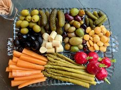 a platter filled with assorted vegetables and fruits