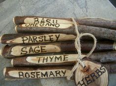 five pieces of wood with words on them and tags attached to the ends that say parsley sage thyme rosemary