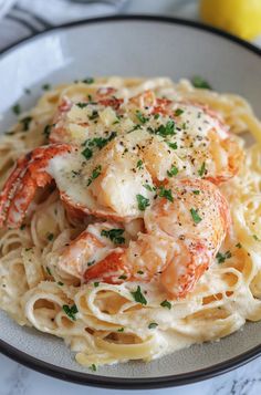 a plate of pasta with shrimp and parmesan cheese