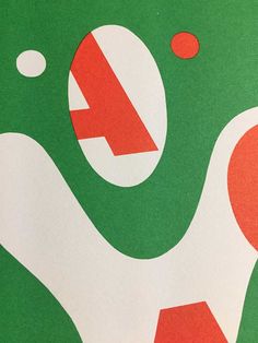 a close up of a green and white wall with red circles on it's surface