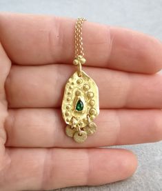 Boho gold necklace 9k 14 k Solid gold necklace with green emerald May birthstone, Yellow gold necklace, Delicate Pendant, Gift for her This solid gold necklace has a rustic textured and is set with a natural green emerald. The pendant has a delicate granulation all around it. This pendant is delicate but has a lot of character, and will upgrade any outfit you'll wear, for everyday use, as for special occasions The pendant can be ordered without the chain too. An excellent choice for anniversary Fine Jewelry Gold Emerald Necklace With Delicate Chain, Gold Emerald Necklace With Delicate Chain, Fine Jewelry, Emerald Necklace With Delicate Chain For May Birthstone, May Birthstone Emerald Necklace With Delicate Chain, Dainty Gold Emerald Birthstone Necklace, Fine Jewelry Emerald Necklace In Gold, Emerald Necklace With Delicate Yellow Gold Chain, Yellow Gold Emerald Necklace With Delicate Chain, Delicate Yellow Gold Emerald Necklace