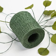 a roll of green twine with leaves on it