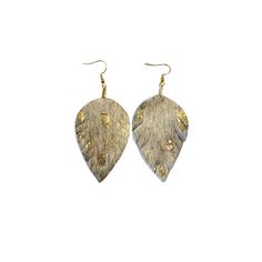 a pair of gold and silver leaf shaped earrings